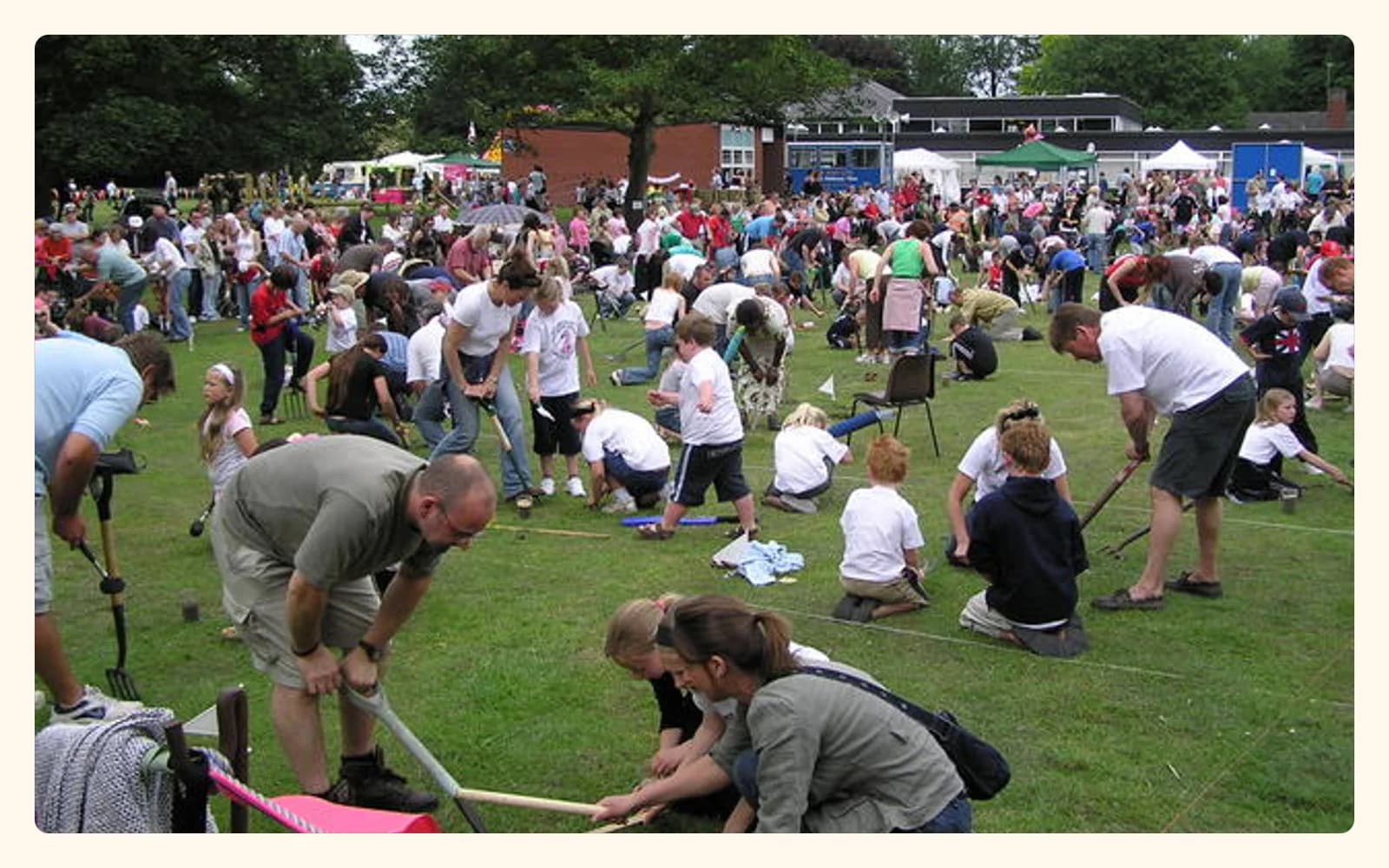 A real crowd crouches over marked grass plots during the 2006 Willaston worm-charming championship.