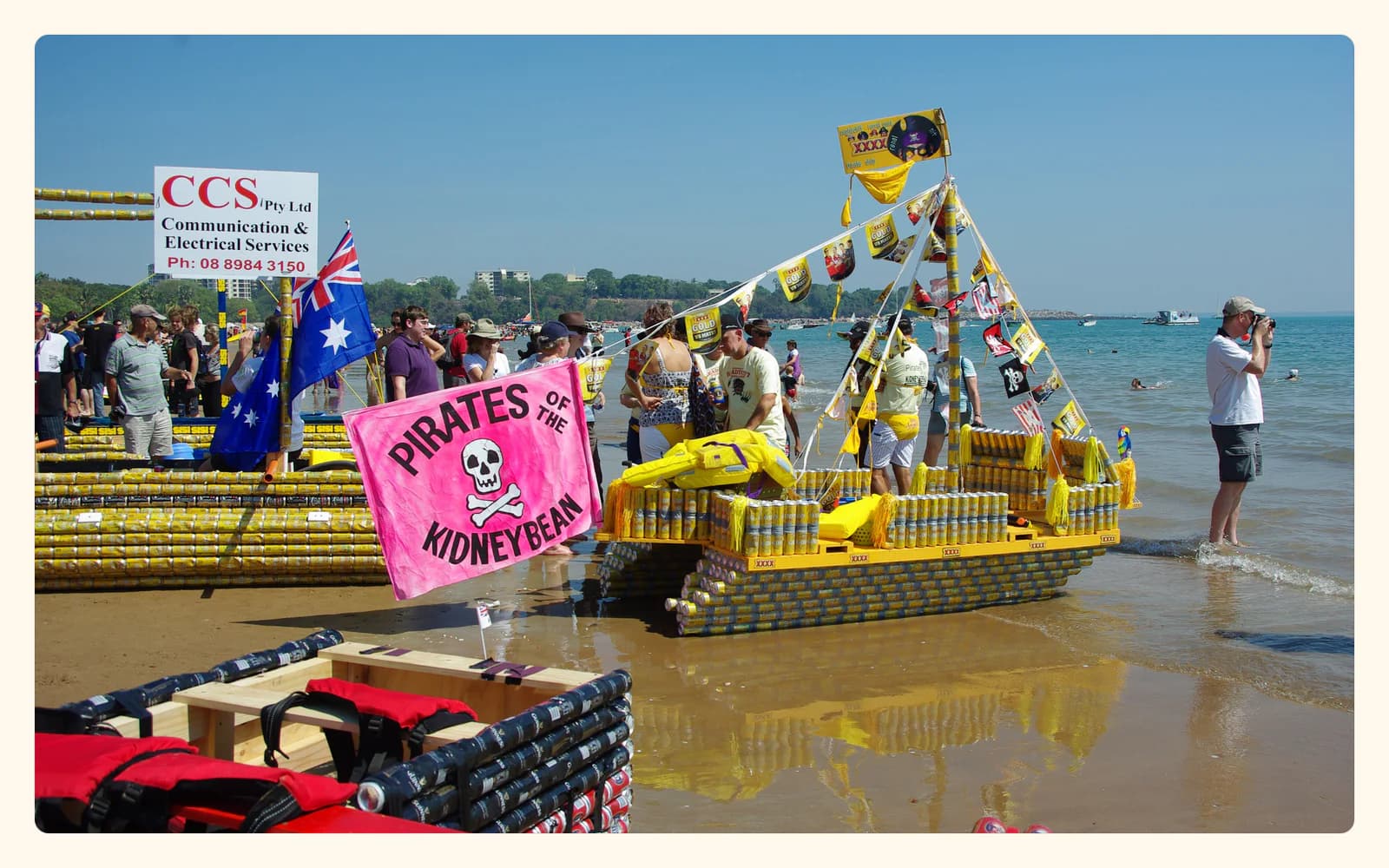 Crews stand beside colorful boats built from rows of drink cans at the 2009 Darwin Beer Can Regatta on Mindil Beach.