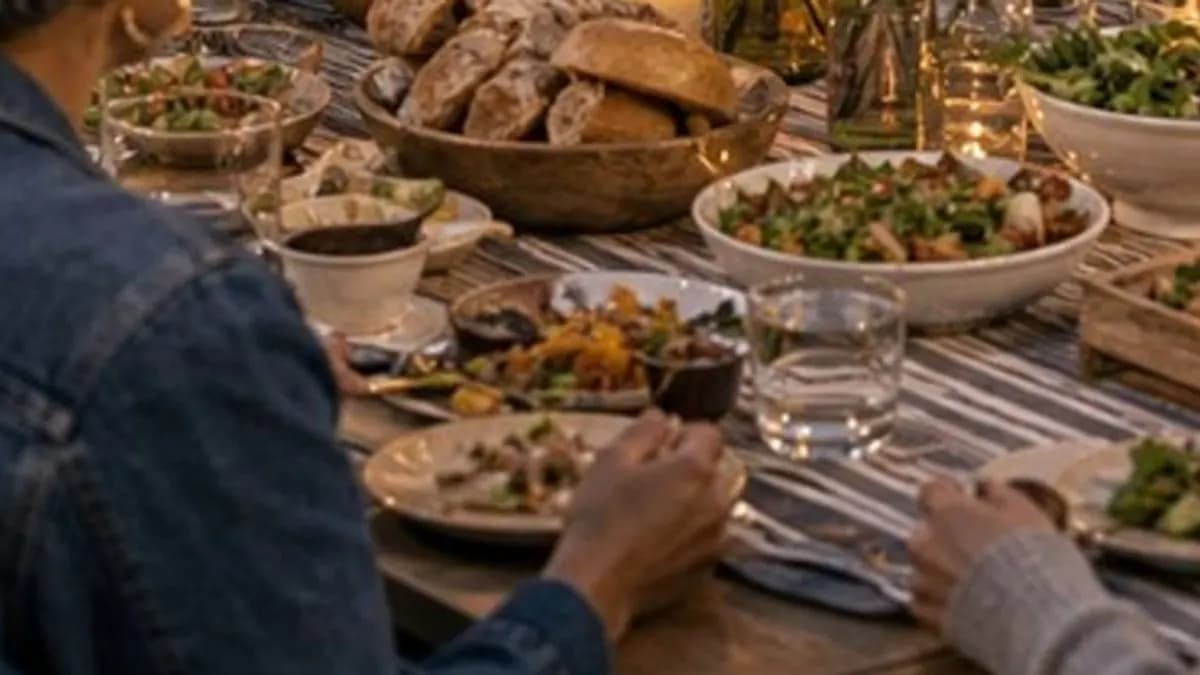 A warm community dinner with people gathered around one table.